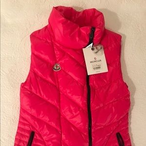 Bright pink moncler vest.